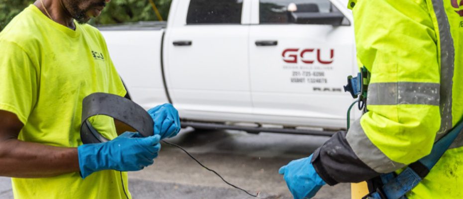 two workers connecting CCTV equipment