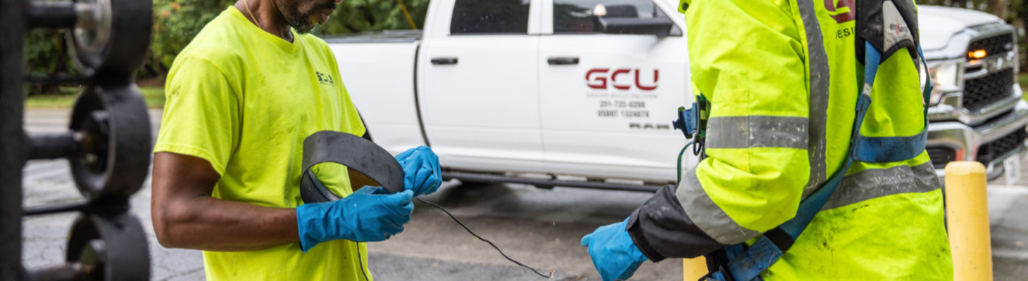 two workers connecting CCTV equipment