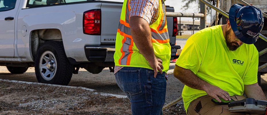 Two workers surveying CCTV