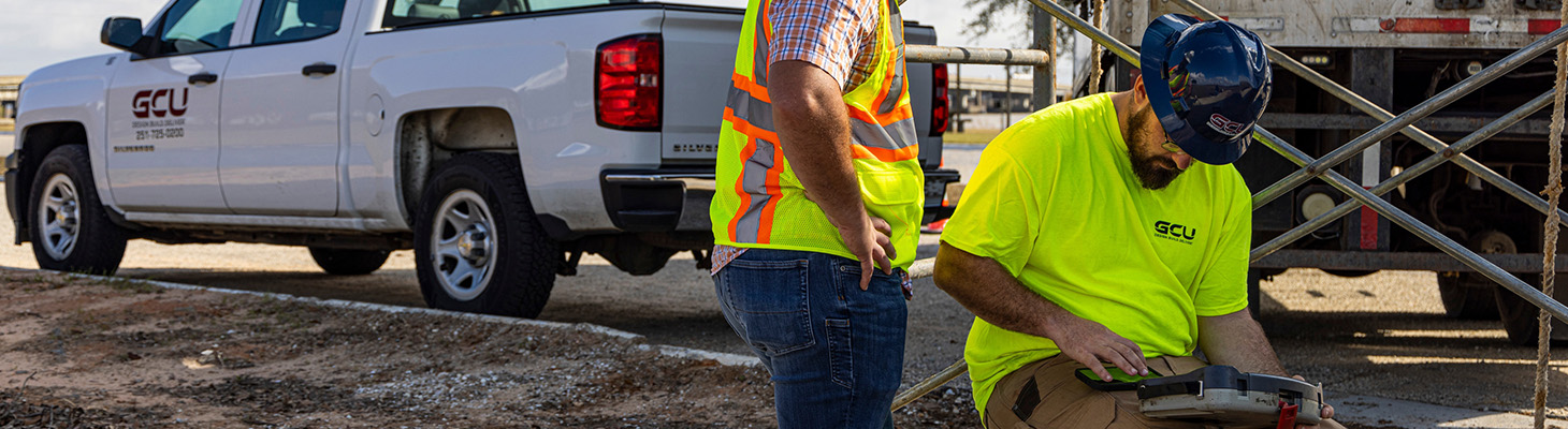 Two workers surveying CCTV